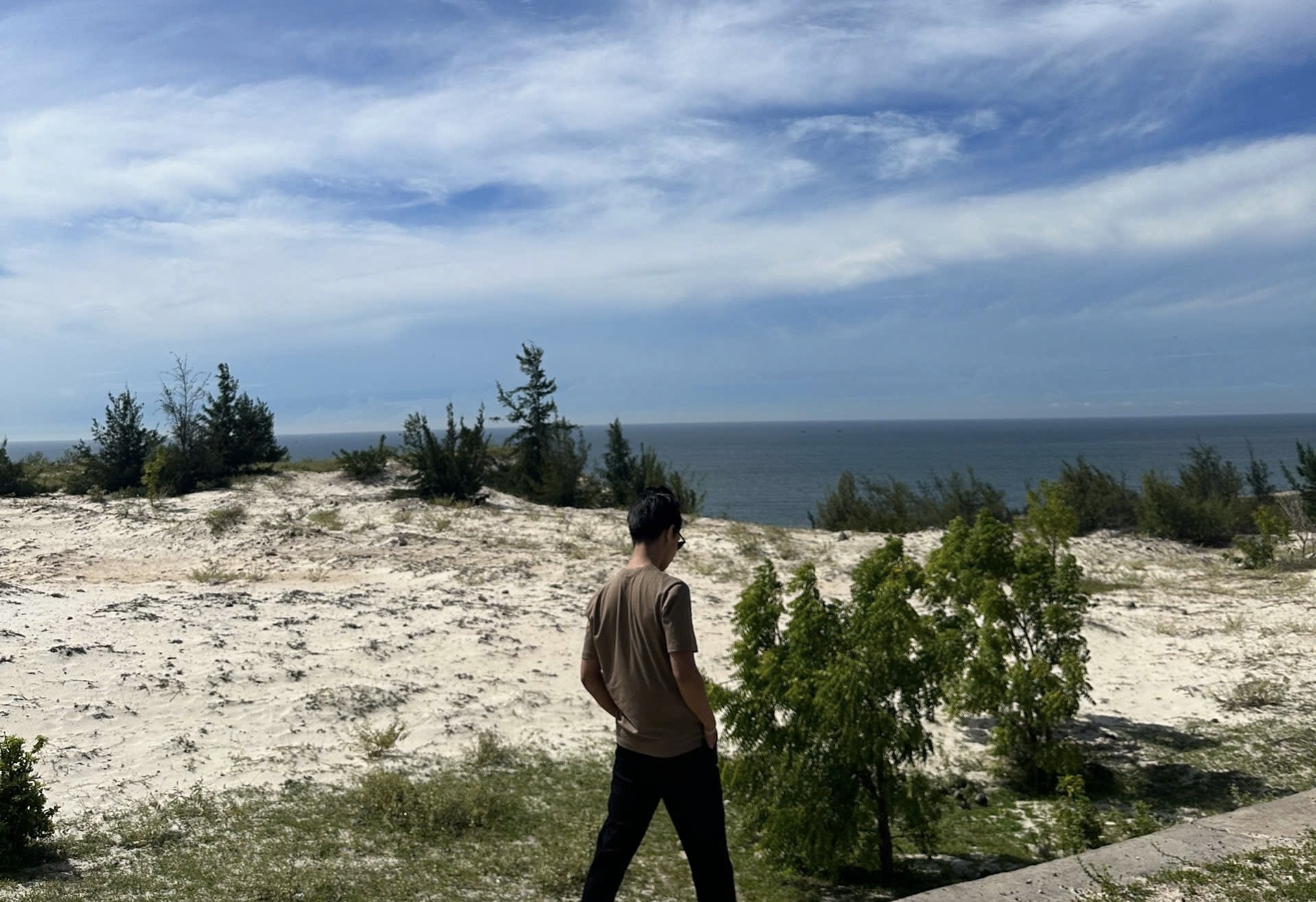 Person walking freely on sand dunes, representing the freedom and peace of mind that comes from automated trading