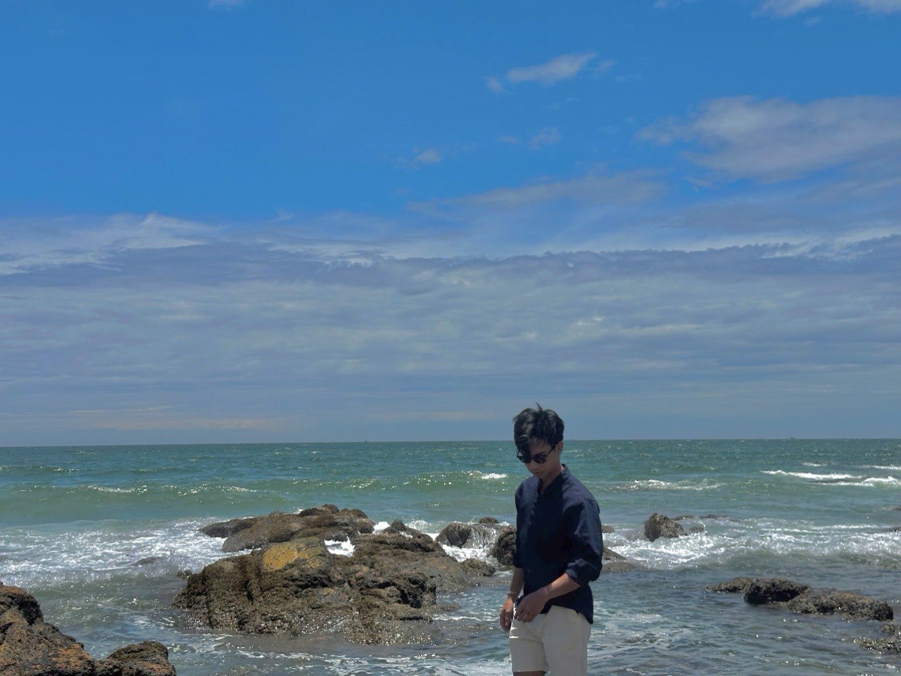 James on the beach, relaxed and free — the automation handles trading while he lives his life